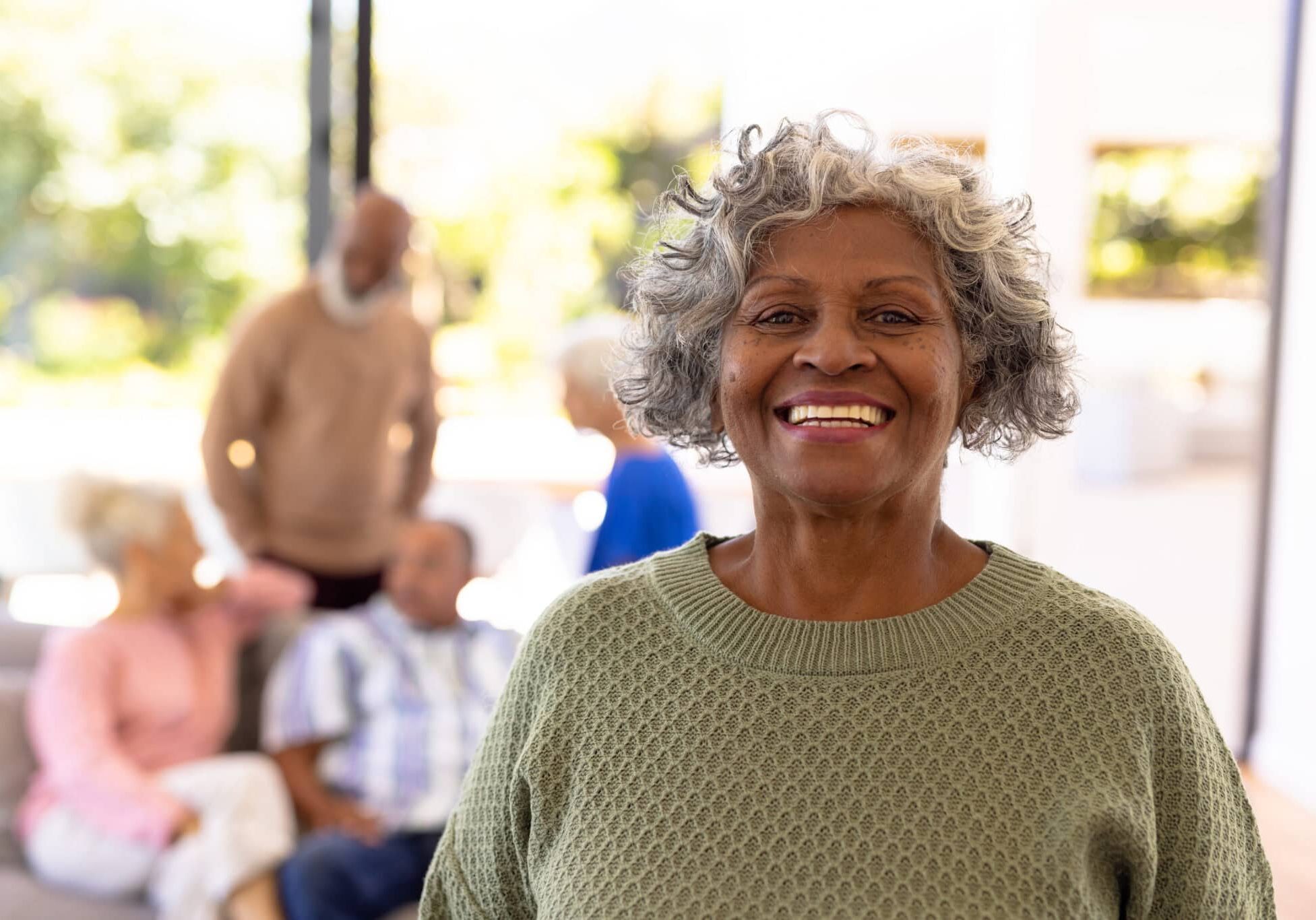 Senior woman smiling in assisted living community.