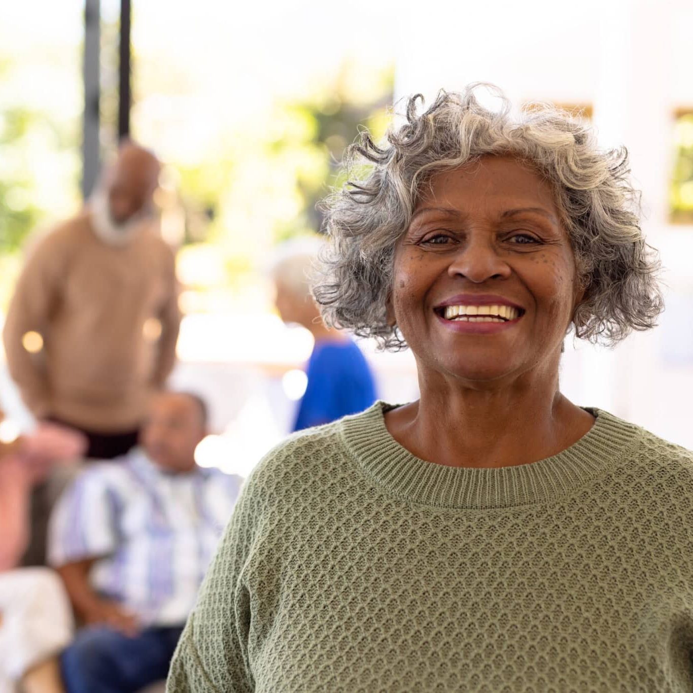 Senior woman smiling in assisted living community.