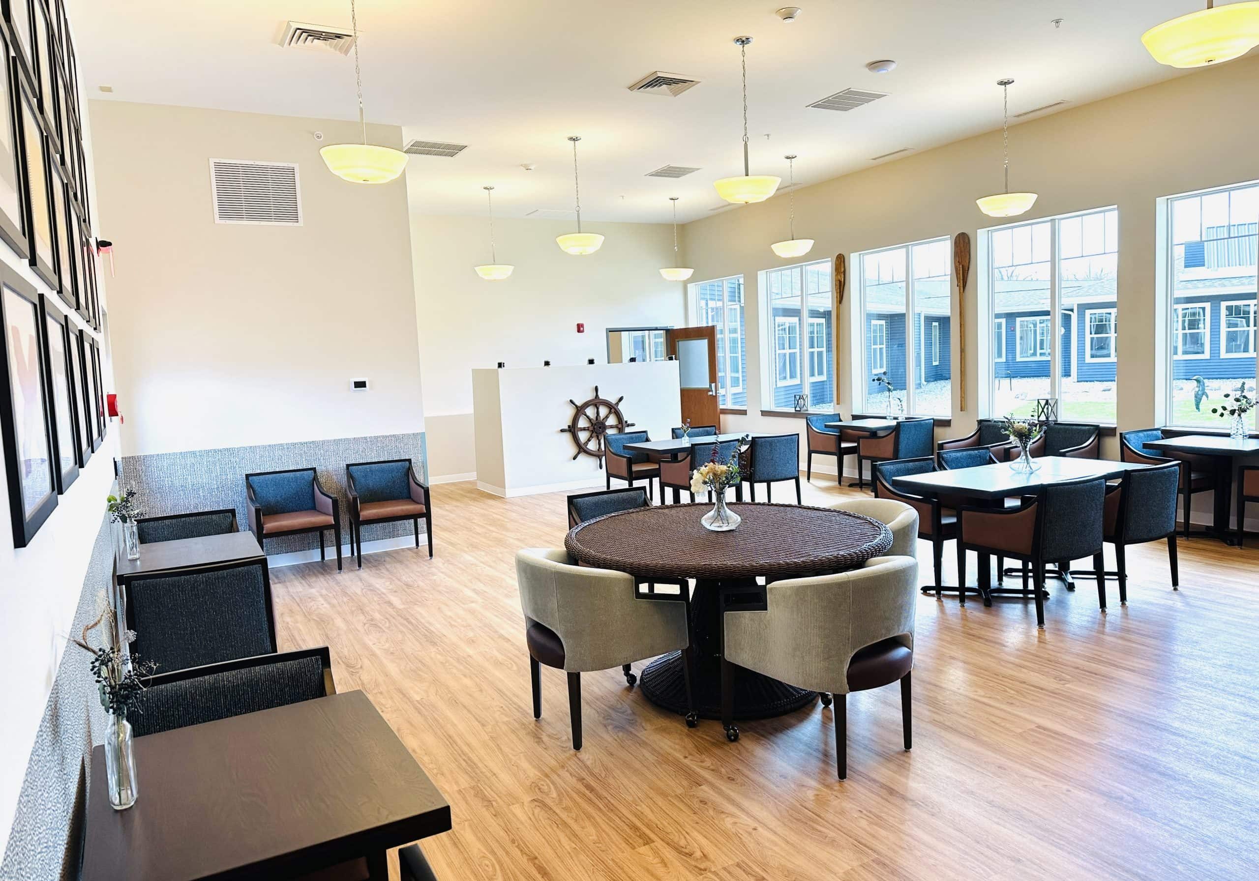 Senior living community common area with cozy seating and large windows.