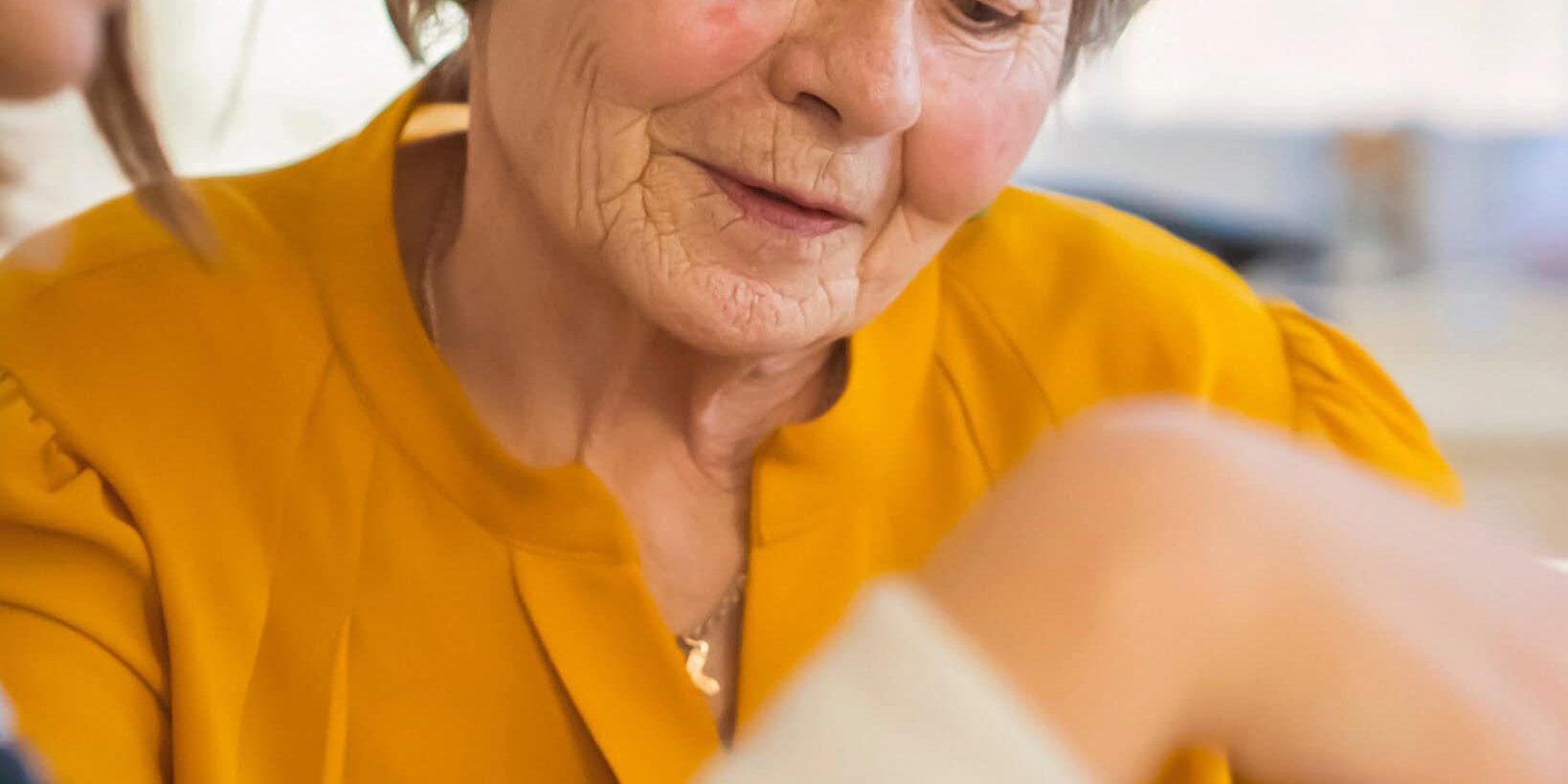 Senior woman receiving attentive care from a caregiver at Bella Largo Senior Living.