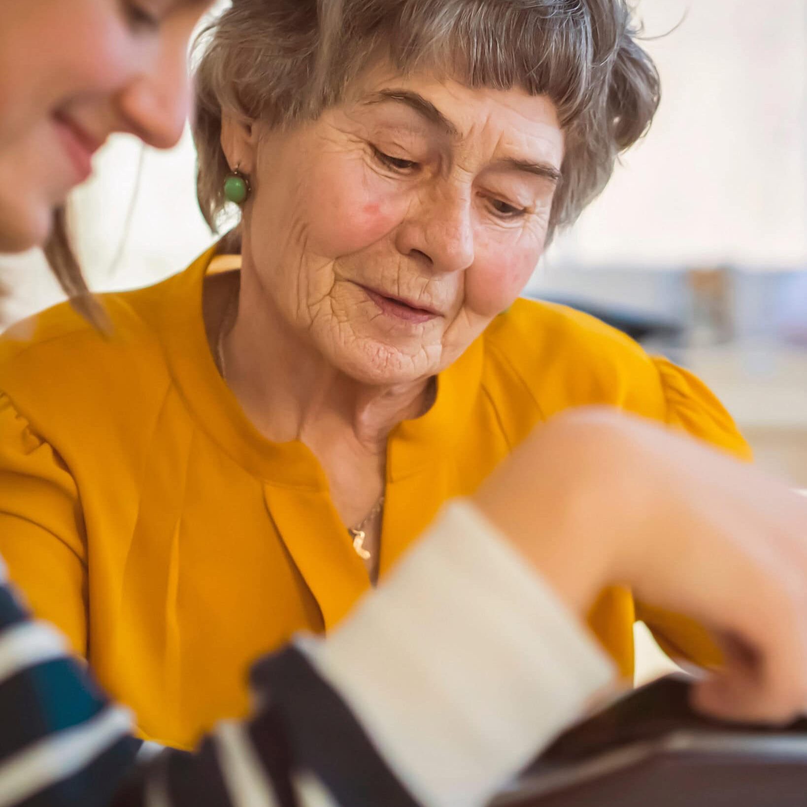 Senior woman receiving attentive care from a caregiver at Bella Largo Senior Living.