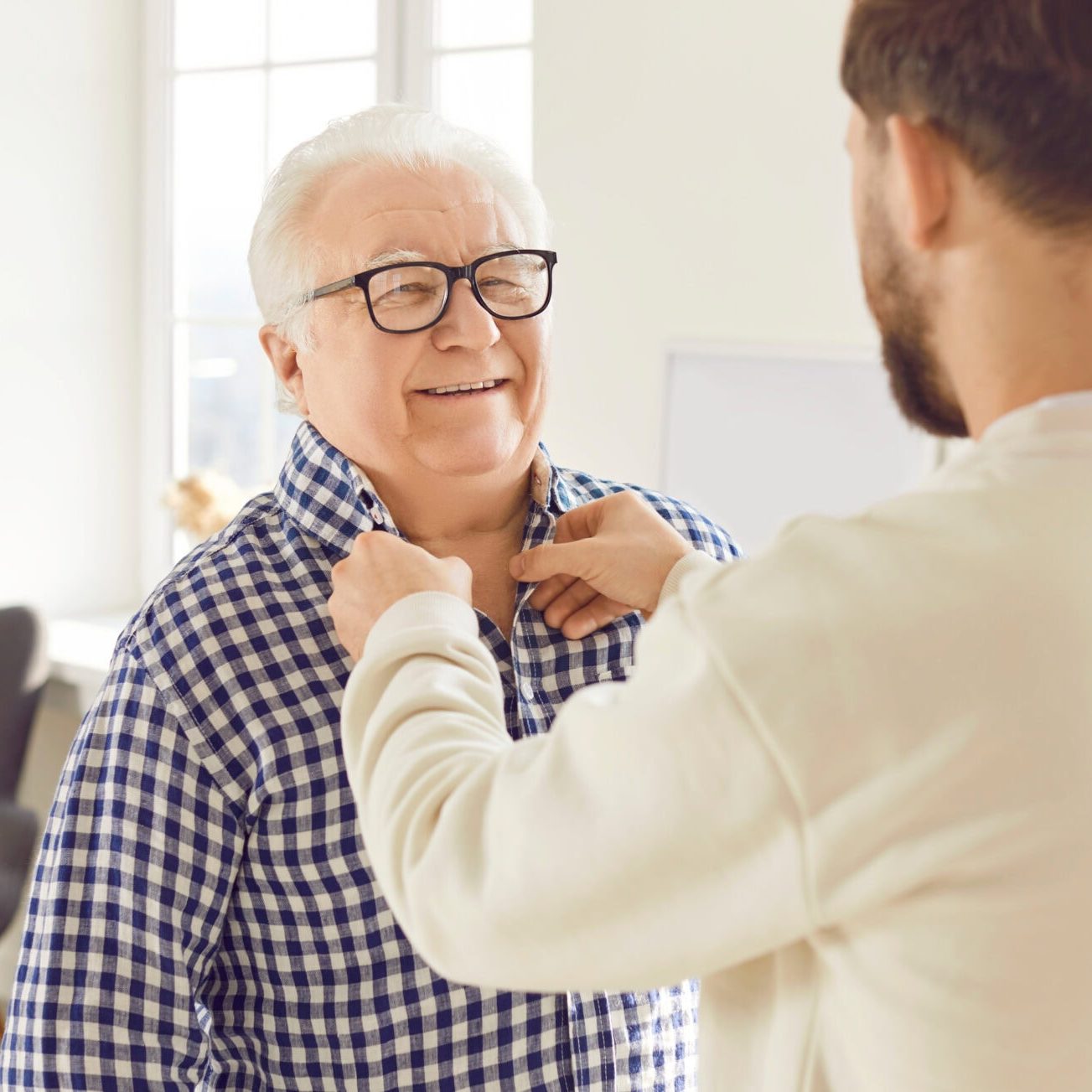 Compassionate caregiver supports an elderly woman in a warm, welcoming environment.